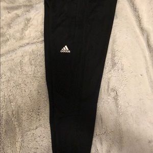 Women all black Adidas joggers with zipper pockets